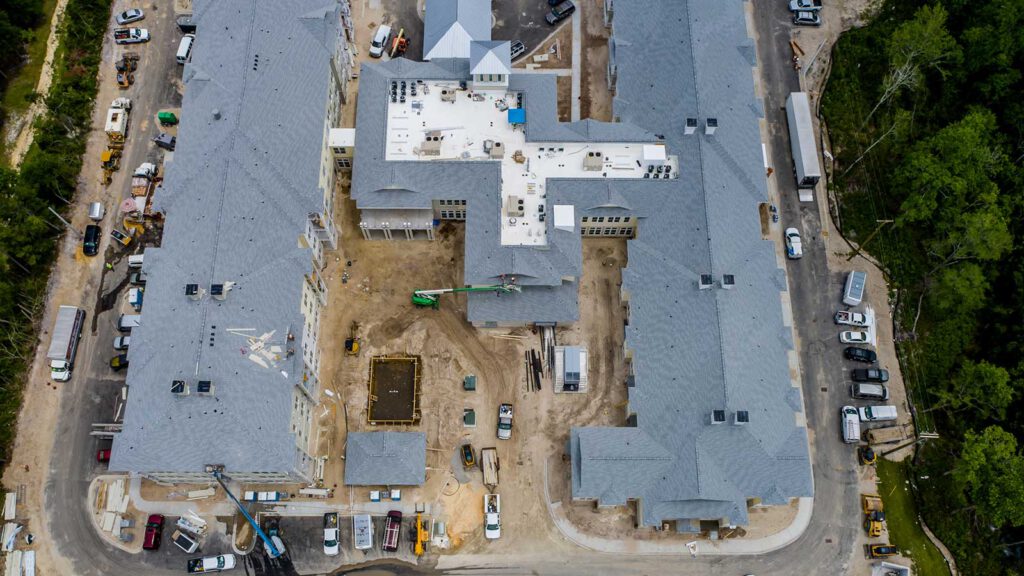 Aerial view of secure outdoor courtyard and swimming pool construction at our brand new independent living, assisted living and memory care community in Little River, SC